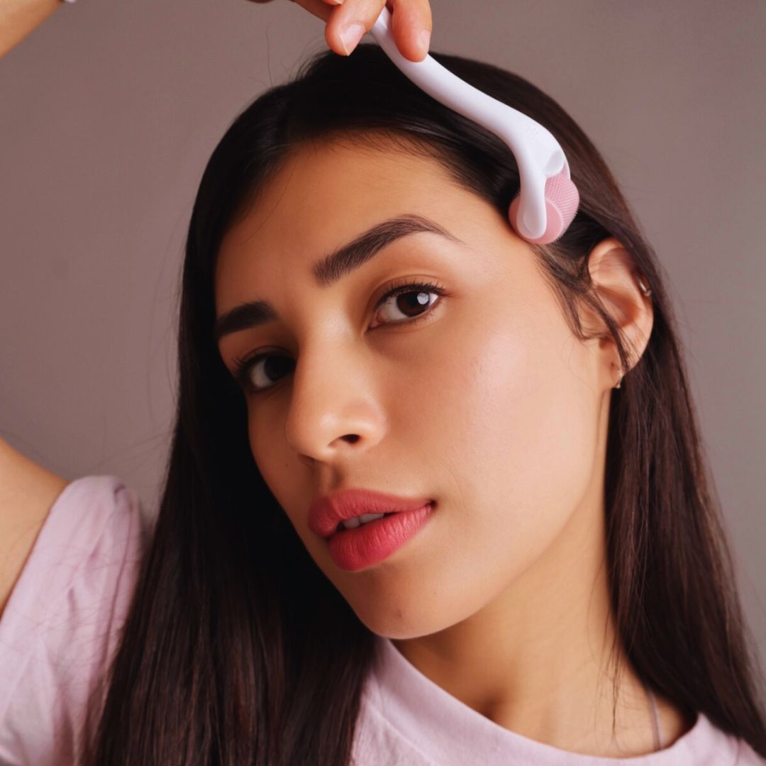 Woman using Miriam's Pink Hair Growth Roller (Dermaroller 1.0mm)