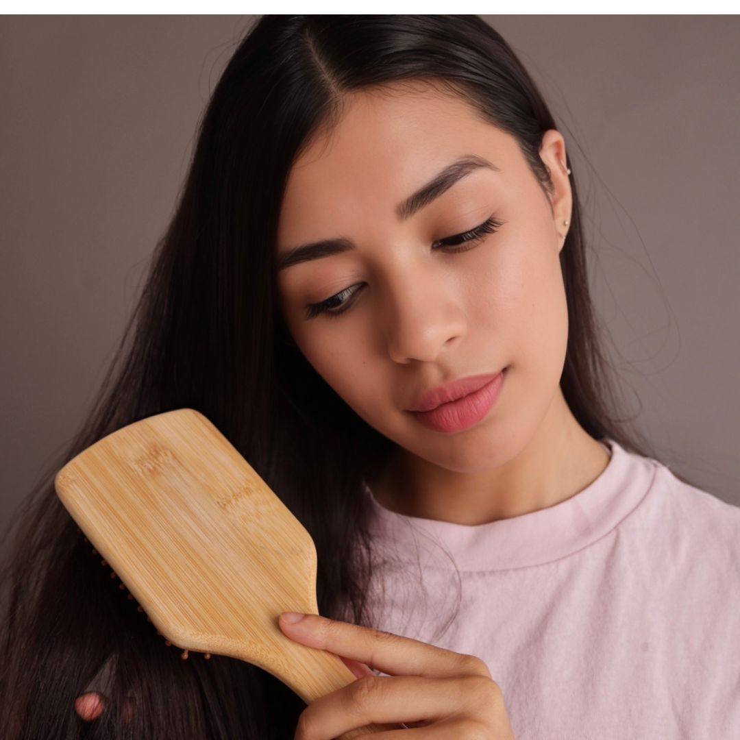 Woman smoothly brushing her hair with Miriam's Natural Bamboo Hair Brush