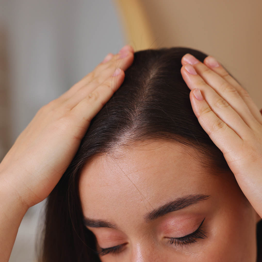 woman using Minoxidil and dermarolling for hair growth