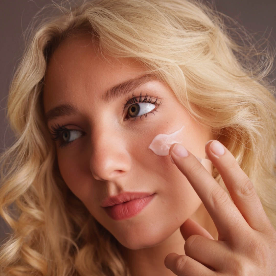 Woman applying rice water face cream